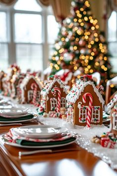 a table set for christmas with gingerbread houses and candy canes