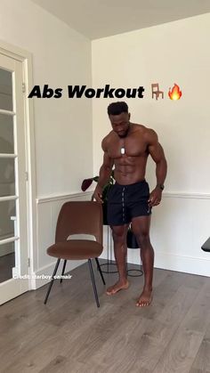 a man standing in front of a chair with his hands on his hips and the words abs workout above him