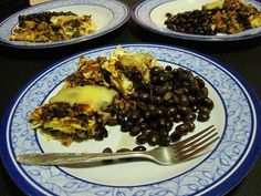 two plates with food on them, one has black beans and the other has rice