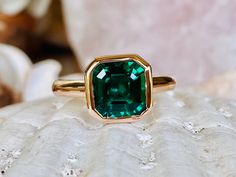 This classic bezel mounting contains a beautiful 2.00 ct. asscher cut lab created emerald. The stone measures approximately 8x8mm. The ring is available in sterling silver, and 14k white, yellow, or rose gold. Please send me a message if you need a size not listed. * This ring can be customized with any color center stone and is available with a matching band. All items are handmade by me in my shop in Woodbridge, NJ. Please message me with any questions. Shipping within the United States is com Formal Octagon Emerald Ring With Bezel Setting, Asscher Cut Emerald Promise Ring, Elegant Asscher Cut Emerald Ring With Bezel Setting, Fine Jewelry Octagon Emerald Ring With Bezel Setting, Classic Emerald Ring With Asscher Cut And Bezel Setting, Gift Emerald Ring With Radiant Cut And Bezel Setting, Octagon Solitaire Emerald Ring, Asscher Cut Emerald Diamond Ring, Emerald Asscher Cut Ring