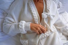 cosy winter statement cardigan made with in rich ivory with plait detailing around the neckline, pockets and cuffs in a super soft wool blend which is built to last. Cardigan is a relaxed fit. Sleeves are made in a contrast honeycomb stitch.