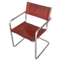 a red leather chair with metal frame and arm rests on a white background in front of the camera