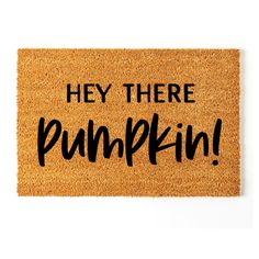 a door mat that says hey there pumpkin on the front with black lettering in it