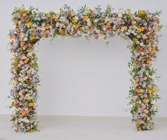 an elaborate floral arch with flowers on it