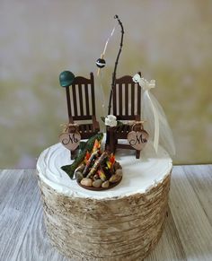 a cake that has two chairs on it with a fishing rod sticking out of the top