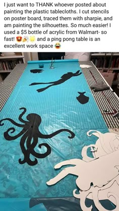 an octopus table cover is on display in the library