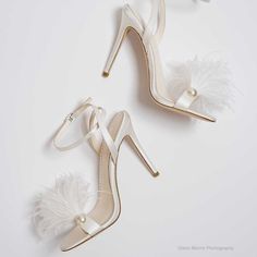 Double Ankle Strap Bridal Shoes with Feathers Reviews say: fit true to size Heel height: 4 inches or 10.2 cm Color: Ivory Handmade Upper Material: Silk Lining Material: Leather lining Sole Material: Leather sole Ankle straps for a secure fit Open toe to show off pedicure Heavy padding for all-day comfort These feather bridal shoes bring movement with every step you take, offset by a pearl on the side of the strap - a fashionable chic wedding stiletto. The double ankle straps elongate your legs w Shoes With Feathers, Luxury Pointed Toe Heels With Feather Trim, Elegant Pointed Toe Heels With Feathers, Luxury Open-heel Wedding Shoes With Heel Strap, Bridal Shoes With Feathers, Elegant Pearl-embellished Open Toe Wedding Shoes, Best Wedding Shoes, Pink Suede Pumps, Rhinestone Wedding Shoes