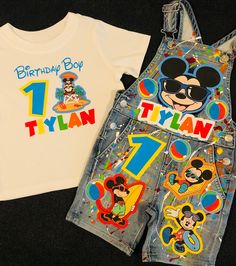 a mickey mouse birthday shirt and overalls are laying next to each other