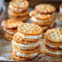 several crackers are stacked on top of each other with cheese and pretzel toppings