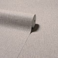 a roll of grey fabric on top of a table