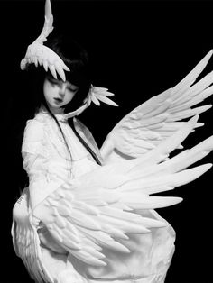 a black and white photo of a woman with wings