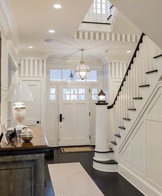 an entry way with stairs and white walls