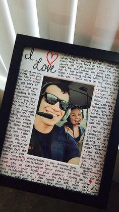 a photo frame with an image of a man and woman in sunglasses on top of it