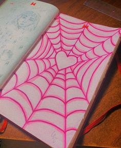 a notebook with a spiderweave drawn on it