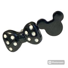 two black and white dice shaped like mickey mouse heads with polka dots on each side