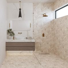 a bathroom with a sink, mirror and bathtub next to a wall mounted shower head