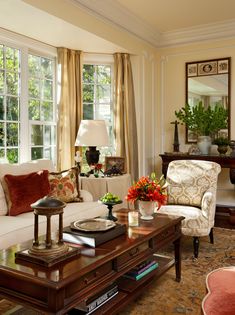 a living room filled with furniture and lots of windows