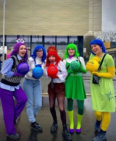 four women dressed in costumes posing for the camera