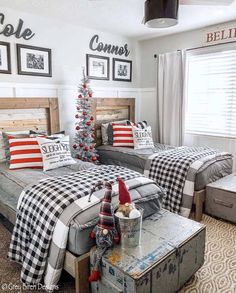 two beds in a bedroom decorated for christmas