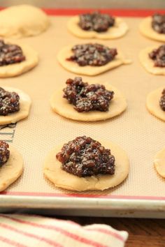 cookies are arranged on top of each other on a cookie sheet, ready to go into the oven