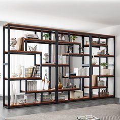 a living room filled with lots of bookshelves next to a wall mounted tv