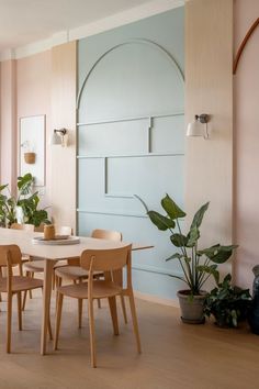 A dining room with a light blue accent wall that blends with modern furnishings. Light Dining Room, Elegant Dining Room