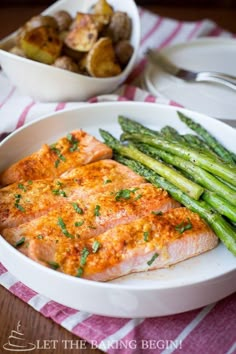 salmon and asparagus on a white plate