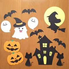 halloween cutouts and decorations on a wooden surface