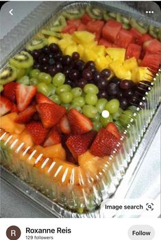 a tray filled with lots of different types of fruit on top of each other,