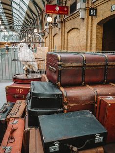 many suitcases are stacked on top of each other