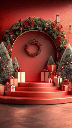 a red stage with presents and christmas trees on the steps in front of it, surrounded by wreaths