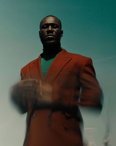 a man in a red suit and green shirt