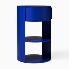 a round blue shelf with two shelves on each side and an open one at the top