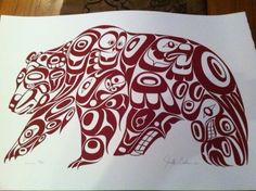 a drawing of a bear made out of native american designs on white paper with red ink