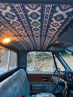 the interior of an old car is decorated with blue and white designs on it's ceiling