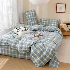 a blue and white checkered comforter on a bed