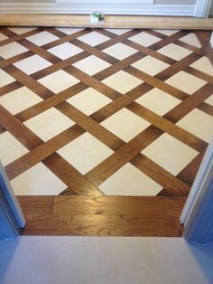 a wooden floor with white and brown squares on it