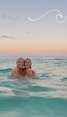 two women in the ocean hugging each other