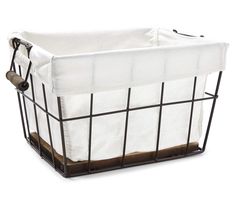 a white and black wire basket with brown handles