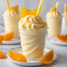 there are orange slices and whipped cream in the cups