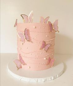 there is a pink cake with butterflies on it