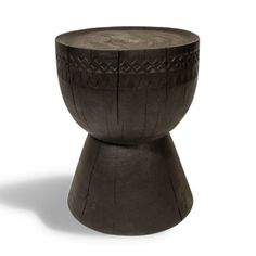 a black wooden stool with an intricate design on it