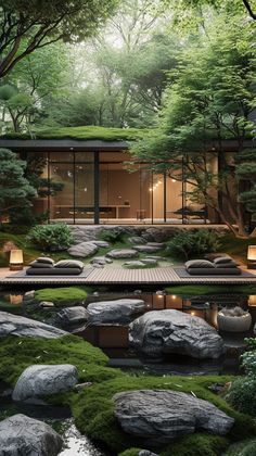 a japanese garden with rocks, grass and lights in the center is surrounded by trees