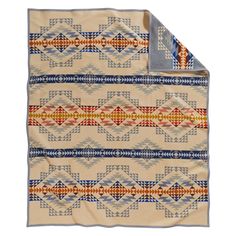 a blanket with an orange, blue and yellow design on the bottom is folded in two rows