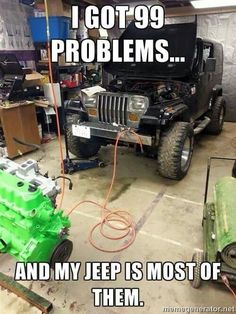 a jeep is parked in a garage with the hood up and it's engine exposed