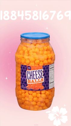 a jar filled with cheese balls on top of a pink background