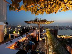 an outdoor bar overlooking the city at night