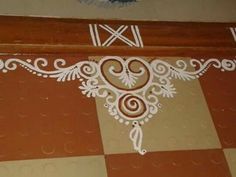 an ornate design on the floor in a room with red and white checkered floors