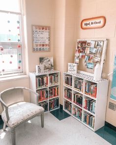 a room with several bookshelves and a chair