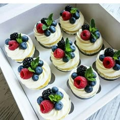 there are many cupcakes with berries on them